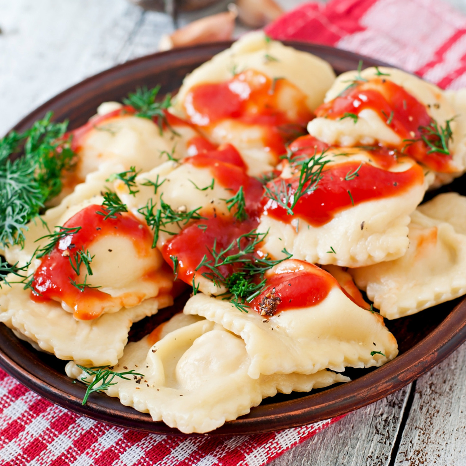 Ravioli with tomato sauce and dill